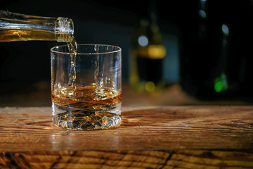 barman pouring whiskey in a bar