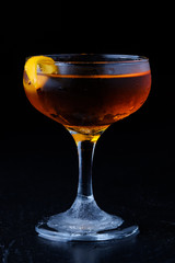 glass of brandy on black background