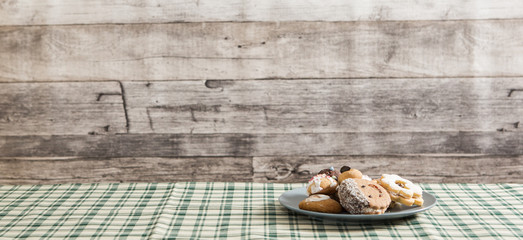 Festive time with home made cookies on the wodden table with wooden background