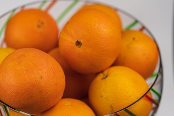 Oranges in a festive Christmas bowl. 