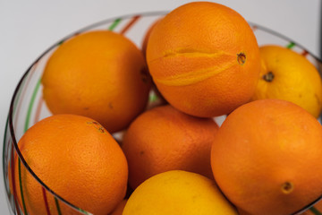 Oranges in a festive Christmas bowl. 