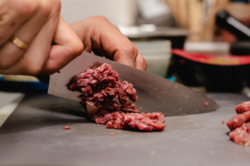 Chef preparing steak tartar of old cow sirloin with 40 days of maturation on restaurant - Powered by Adobe