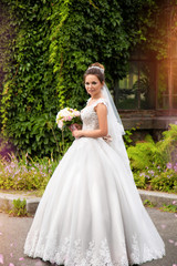 Young bride wearing gorgeous wedding dress, playing with veil. plays a wedding dress. Dress develops in the wind. Happy bride in a wedding dress is spinning.