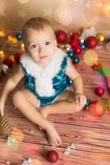 Fototapeta na wymiar a little boy in a blue Christmas suit. new year. child