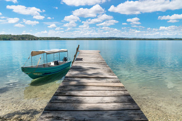 Boat at a dock at lake Itza with turquoise water, El Remate, Peten, Guatemala