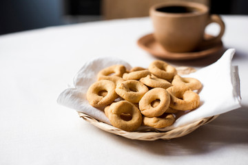 Rosquillas de queso served in a handmade palm tray accompanied by a cup of coffee. Nicaraguan breakfast/snack. No people.