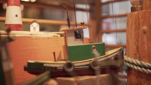 This was taken at a higher frame rate and has been converted to a slow motion video clip. Smooth footage of a toy wooden boat.