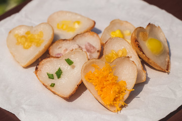 Khanom khrok, the ancient Thai desserts. They are prepared by mixing rice flour, sugar, and coconut milk to form a dough. Create by Heart shaped. Capture by selective focus.