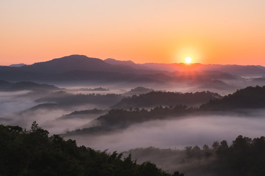 Sunrise on the mountain in winter and fog floats over the mountains. - Powered by Adobe
