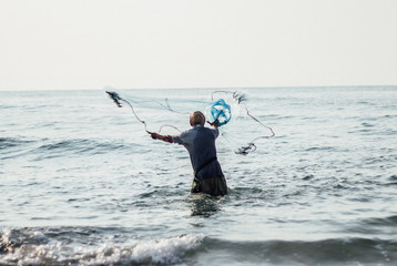 Fisherman Fishing Nets on the sea Thailand