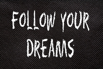 Black background of pattern texture with Follow Your Dreams  words