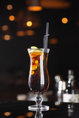 glass of whiskey and ice on wooden table