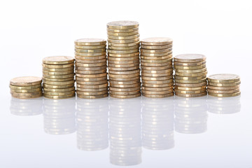 A stack of Australian one dollar gold coins set against a white background.