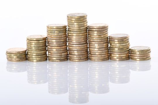 A Stack Of Australian One Dollar Gold Coins Set Against A White Background.