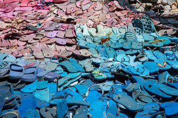 old blue and pink flip flops for recycling