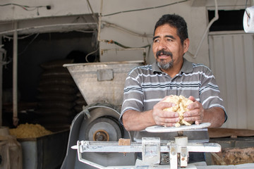 man selling dough in nixtamal mill