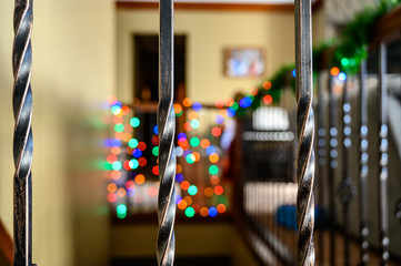 oiled bronze interior stair banister with bokeh lights in the background