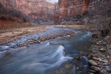 Desert red rocks with running creek in Zion National Park