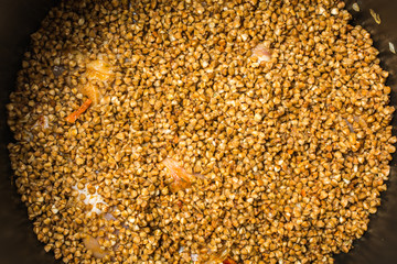 Delicious cooked buckwheat porridge with chicken legs in slow cooker.