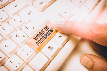 Conceptual hand writing showing Work In Progress. Concept meaning unfinished project that still...