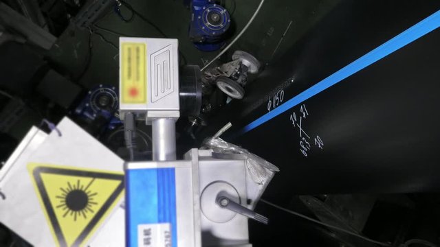 Laser Marking Machine Engraving. Manufacture of plastic water pipes of the factory. Process of making plastic tubes on the machine tool with the use of water and air pressure.
