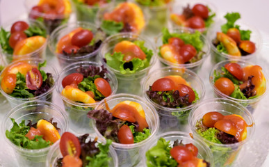 Delicious salad in plastic cup