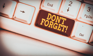 Text sign showing Don T Forget. Business photo text used to remind someone about important fact or detail White pc keyboard with empty note paper above white background key copy space