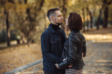 Fototapeta premium Young hugging couple of lovers in the autumn park.