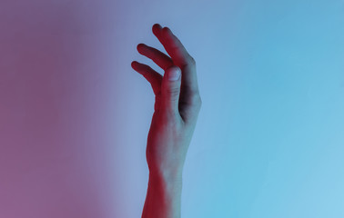 Female hand. mystical concept. Creative pop art pink blue neon color. Trendy gradient illumination. Night light