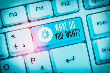 Text sign showing What Do You Want Question. Business photo showcasing say or write in order to ask demonstrating about something White pc keyboard with empty note paper above white background key