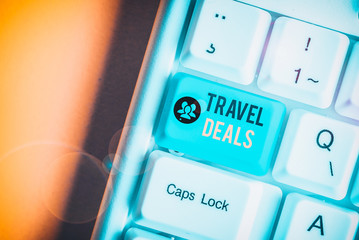 Writing note showing Travel Deals. Business concept for holiday organized by a travel company and pay fixed price White pc keyboard with note paper above the white background