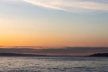 bright blue water of puget sound along shoreline of washington