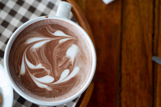 Hot chocolate latte art in white cup