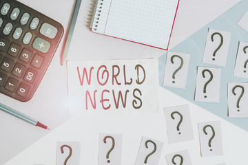 Writing note showing World News. Business concept for global noteworthy information about recent or important events Mathematics stuff and writing equipment above pastel colours background