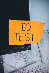 Writing note showing Iq Test. Business concept for attempt to measure your cognitive ability huanalysis intelligence Notation paper computer monitor screen near white keyboard