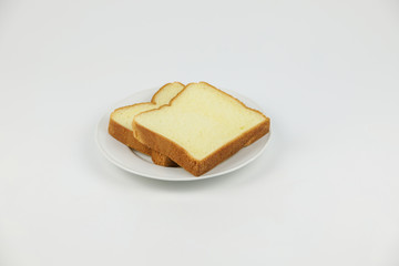 Sliced bread on white plate on white background