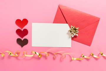 Valentine love message composition with empty white card and golden bow