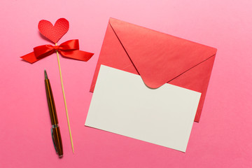 Valentine day greeting card with pink envelope and white empty card, Parker pen and red heart on...