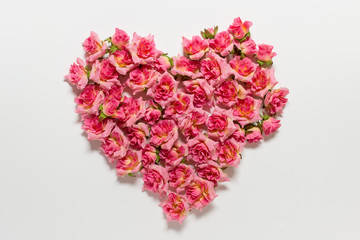 Fototapeta premium Romantic Valentines day greeting card with heart made of pink roses on white backgound.