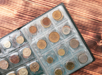 Old coins in a collection book