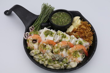 Thai spicy seafood salad with shrimp, squid and oyster with seafood sauce