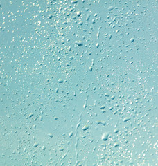 Drops of water on a blue glass window