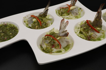 Thai raw shrimp salad with seafood sauce in white plate