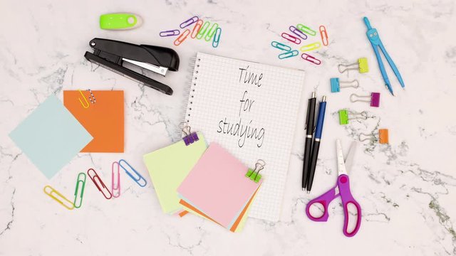 Time for studying title appear on notebook surrounded with school supplies - Stop motion 