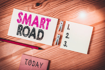 Conceptual hand writing showing Smart Road. Concept meaning number of different ways technologies are incorporated into roads Colored crumpled papers wooden floor background clothespin