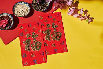 Red traditional greeting cards wishing good luck on table served for Chinese New Year