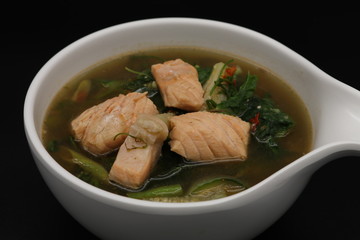 Thai herb soup with salmon on top