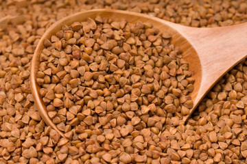 Buckwheat with a wooden spoon, background image.
