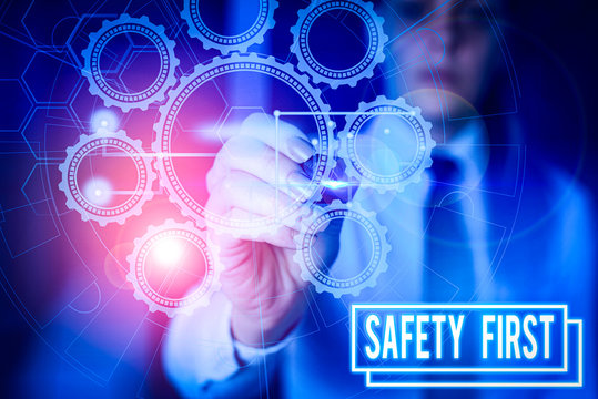 Writing note showing Safety First. Business concept for used to say that the most important thing is to be safe Picture photo network scheme with modern smart device