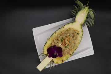 Fried rice in pineapple on white plate